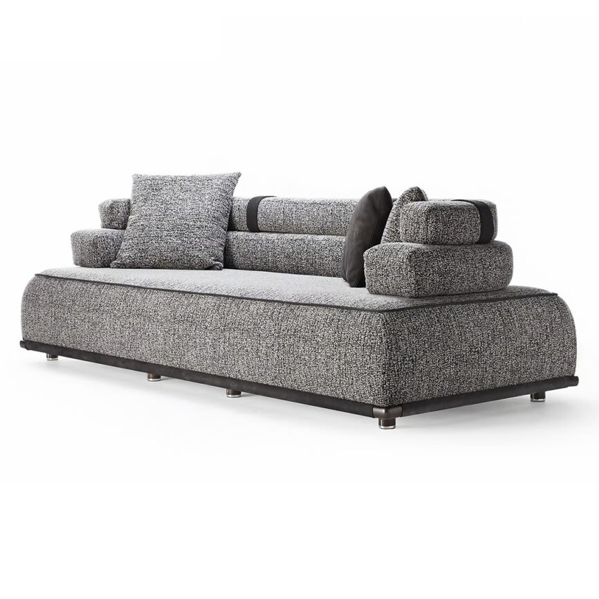 Gray PANAREA sofa with generous proportions, featuring luxurious fabrics and leather inserts, designed for comfort and visual appeal.