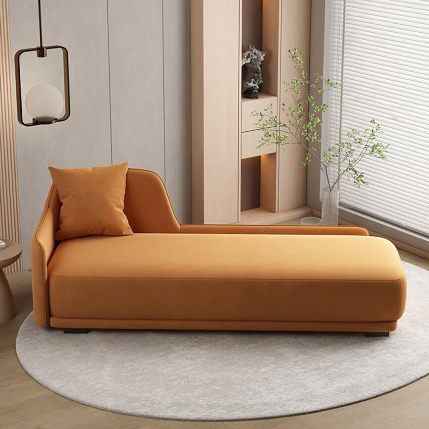 Mustard-colored chaise lounge in a modern living room setting with soft lighting and elegant decor.