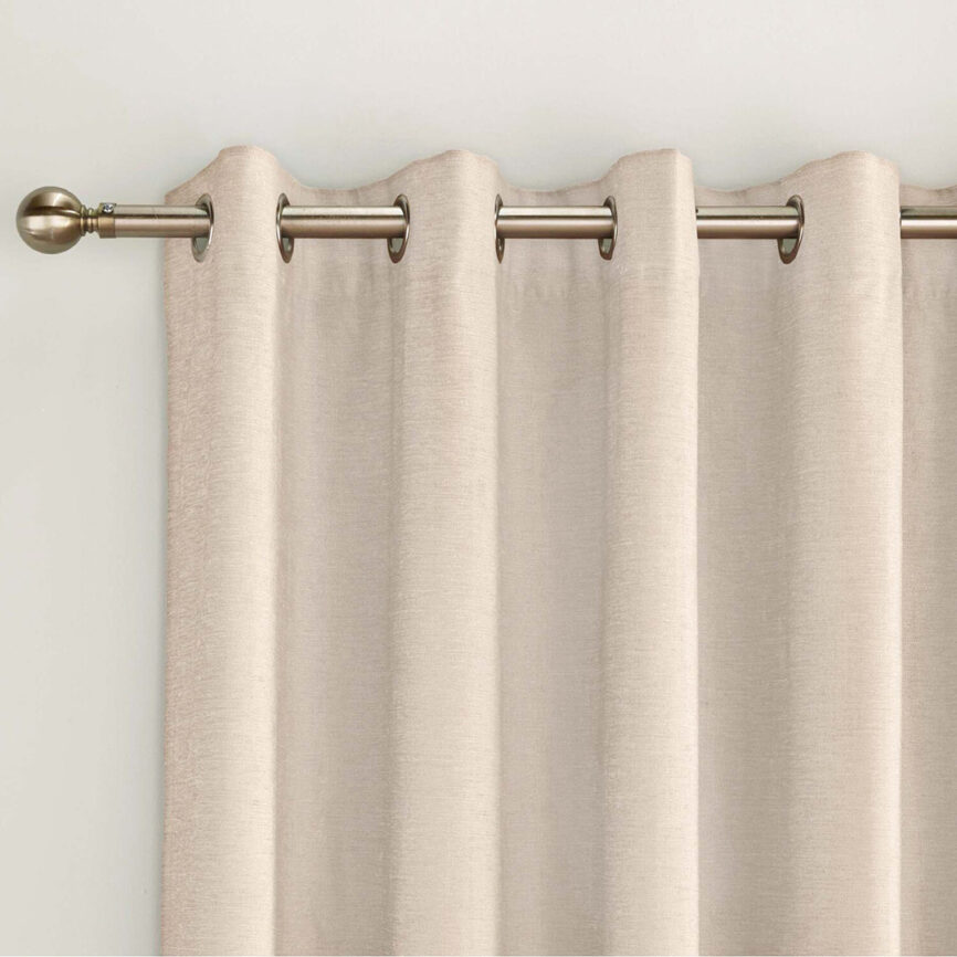 Beige blackout curtain with grommet top, custom-made for privacy and light control in UAE interiors.