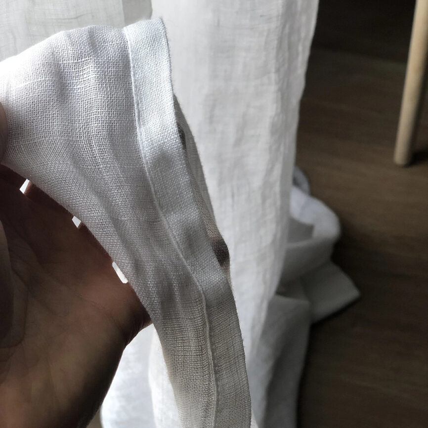 Custom-made elegant sheer curtain in soft fabric, designed to gently filter light while maintaining privacy - ideal for living spaces and open interiors.