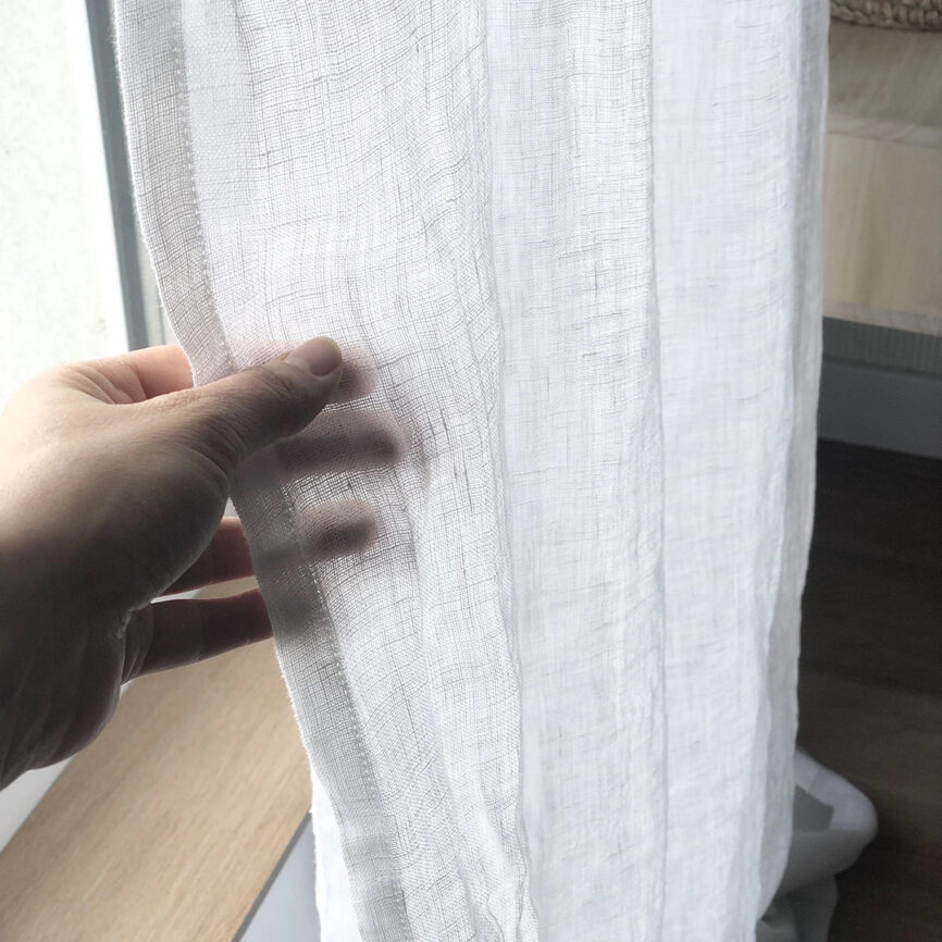 Custom-made elegant sheer curtain in soft fabric, designed to gently filter light while maintaining privacy - ideal for living spaces and open interiors.