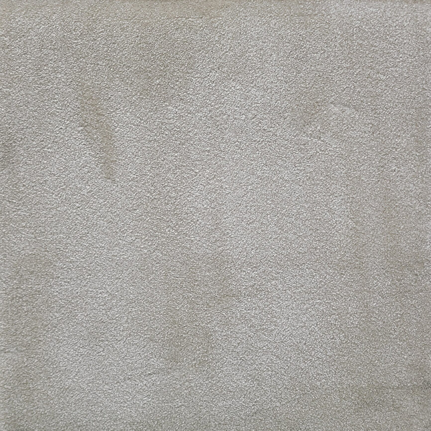 A close-up of the Absolute Comfort Carpet, featuring a plain, refined surface with a soft texture and elegant finish.