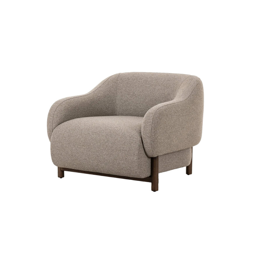 Alora armchair placed in a modern living room with warm-toned décor