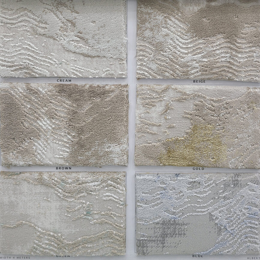 A close-up of the Elite Wave Carpet, featuring an elegant textured surface with flowing wave-like patterns in varying shades