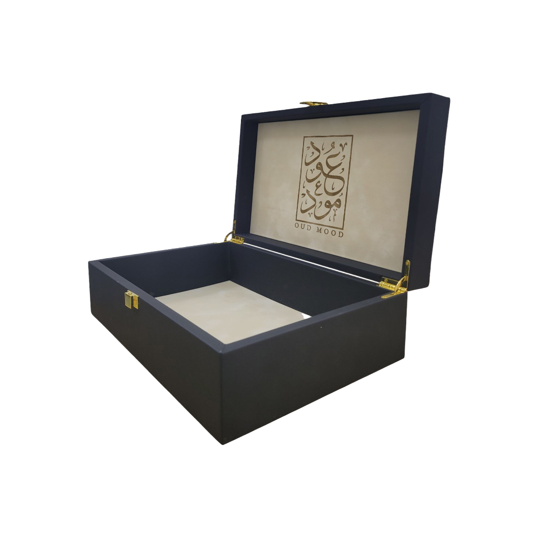 Elegant black perfume box with gold accents and Arabic calligraphy, showcasing a luxurious design.