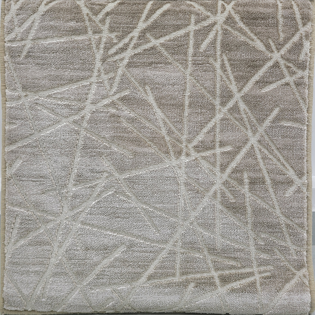 A close-up view of the Sable Luxe Carpet, showcasing its smooth, plain texture and premium craftsmanship in a neutral-toned finish.
