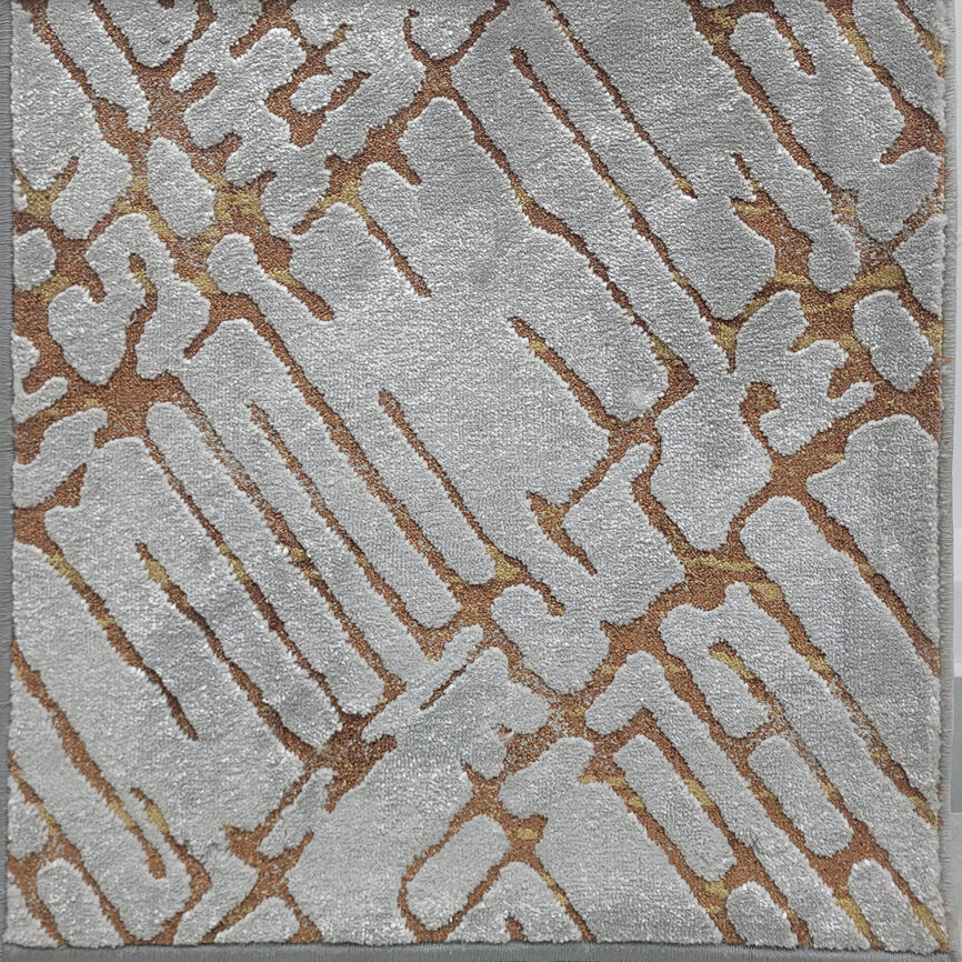 A close-up of Sandy Crest Carpet, featuring soft, flowing textures inspired by natural sand dunes, available in six elegant color variations.