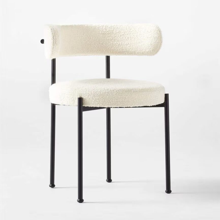 Inesse dining chair with ivory boucle upholstery and matte black steel frame, handcrafted by MZ FURNITURE in UAE.