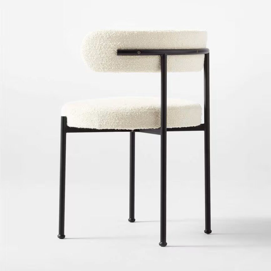 Inesse dining chair with ivory boucle upholstery and matte black steel frame, handcrafted by MZ FURNITURE in UAE.