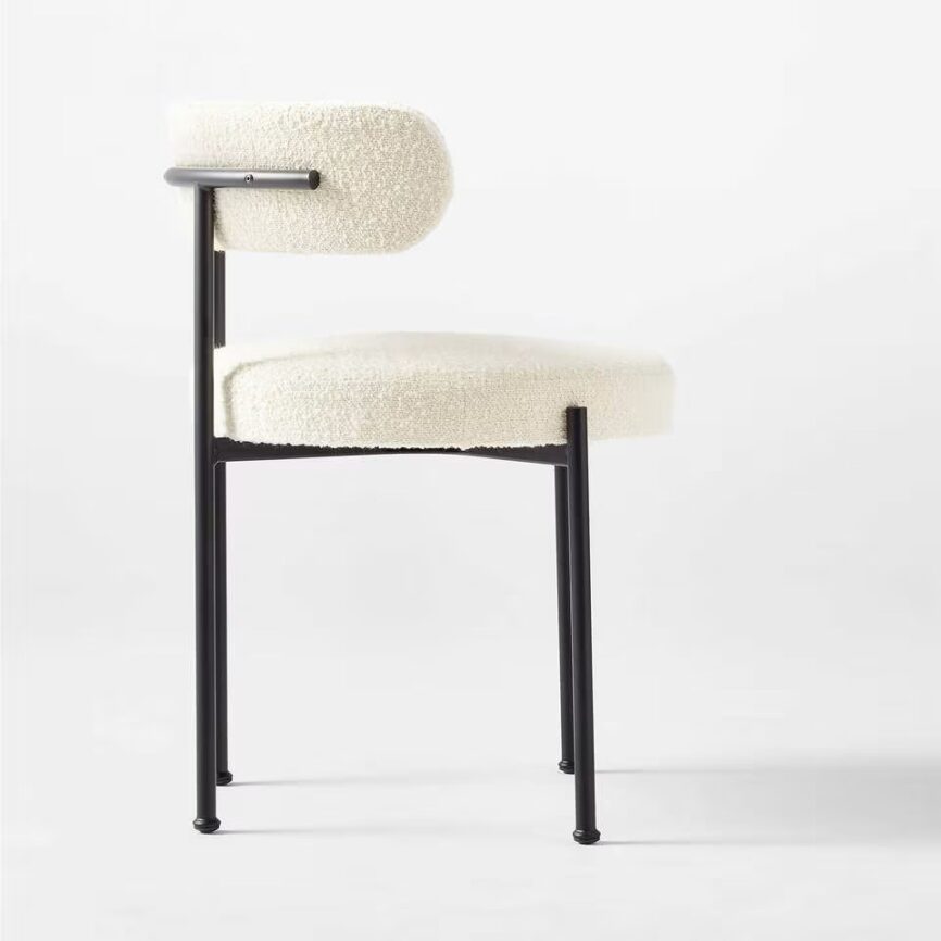 Inesse dining chair with ivory boucle upholstery and matte black steel frame, handcrafted by MZ FURNITURE in UAE.
