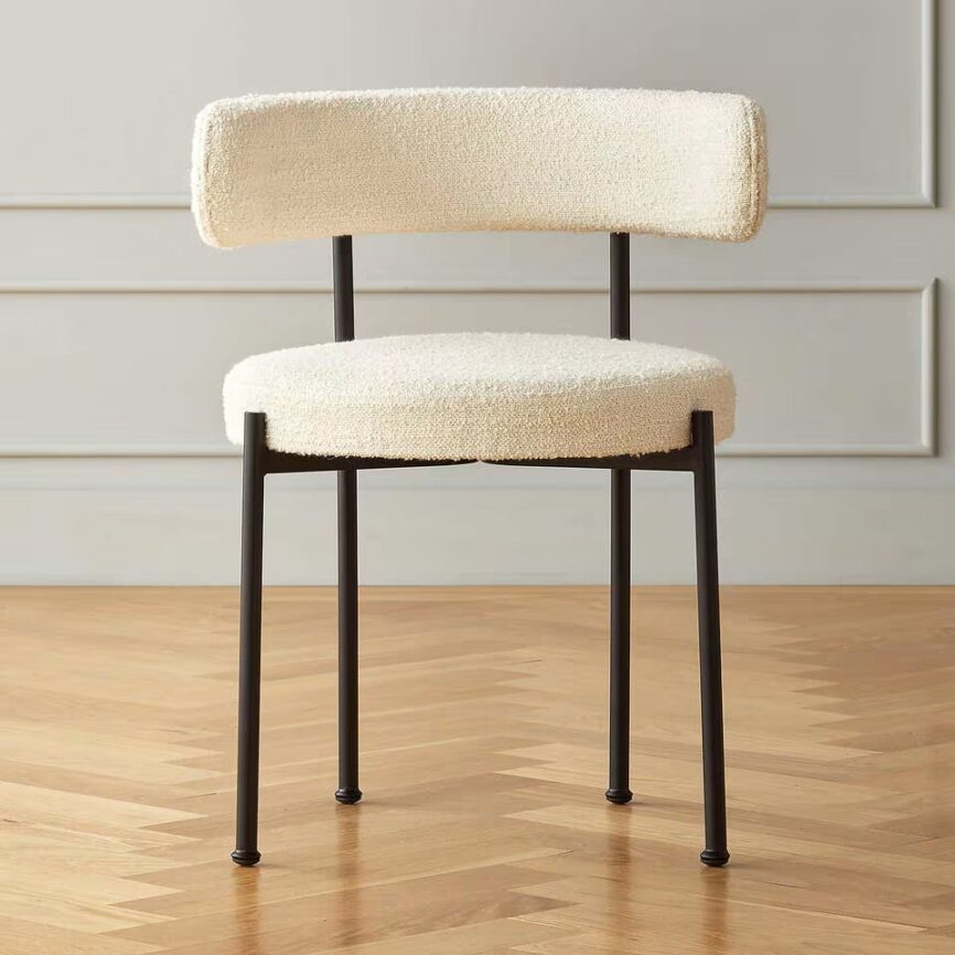 Inesse dining chair with ivory boucle upholstery and matte black steel frame, handcrafted by MZ FURNITURE in UAE.