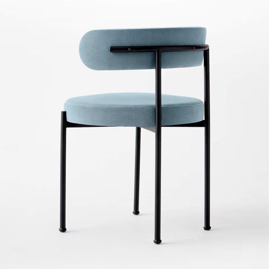 Inesse dining chair with ivory boucle upholstery and matte black steel frame, handcrafted by MZ FURNITURE in UAE.