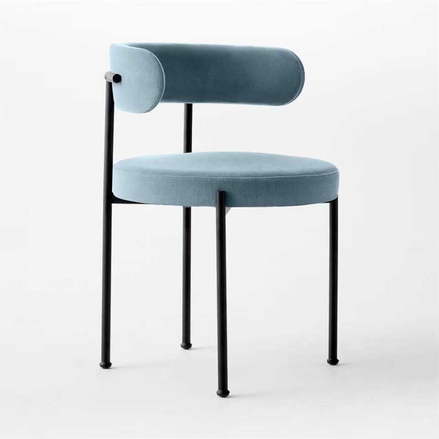 Inesse dining chair with ivory boucle upholstery and matte black steel frame, handcrafted by MZ FURNITURE in UAE.