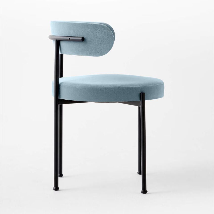 Inesse dining chair with ivory boucle upholstery and matte black steel frame, handcrafted by MZ FURNITURE in UAE.