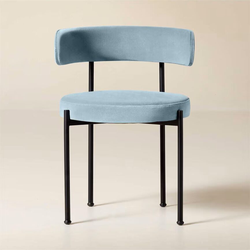 Inesse dining chair with ivory boucle upholstery and matte black steel frame, handcrafted by MZ FURNITURE in UAE.