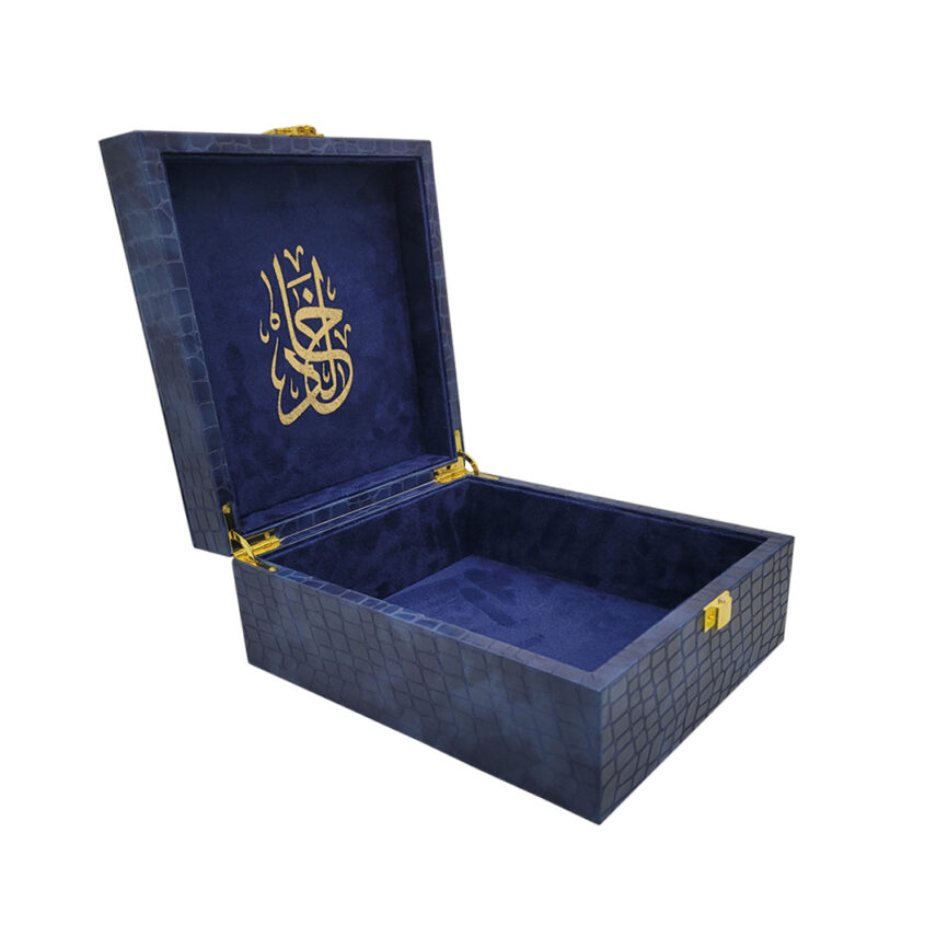 Open blue velvet-lined box with golden Arabic calligraphy on lid interior